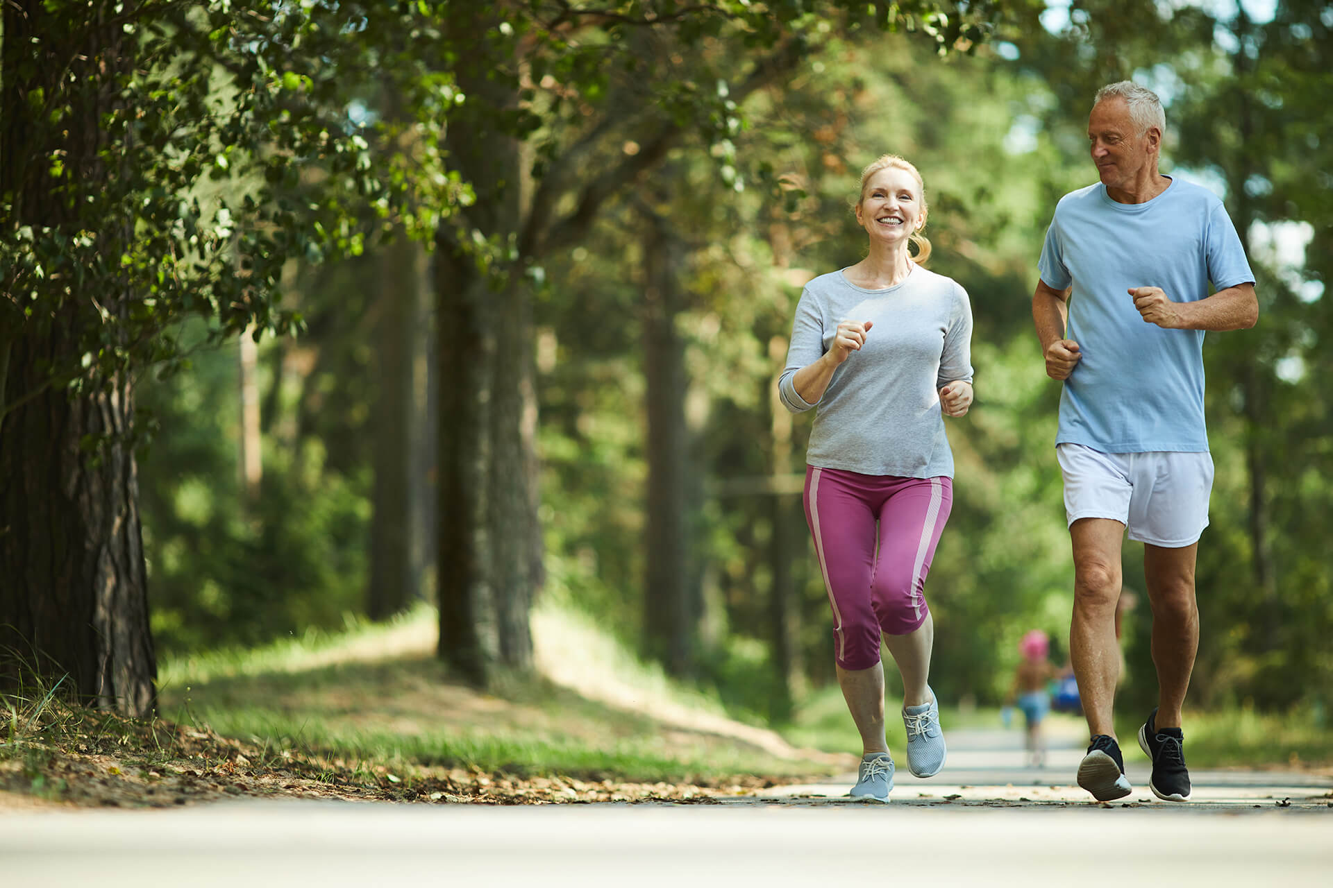 Healthy couple jogging in park
