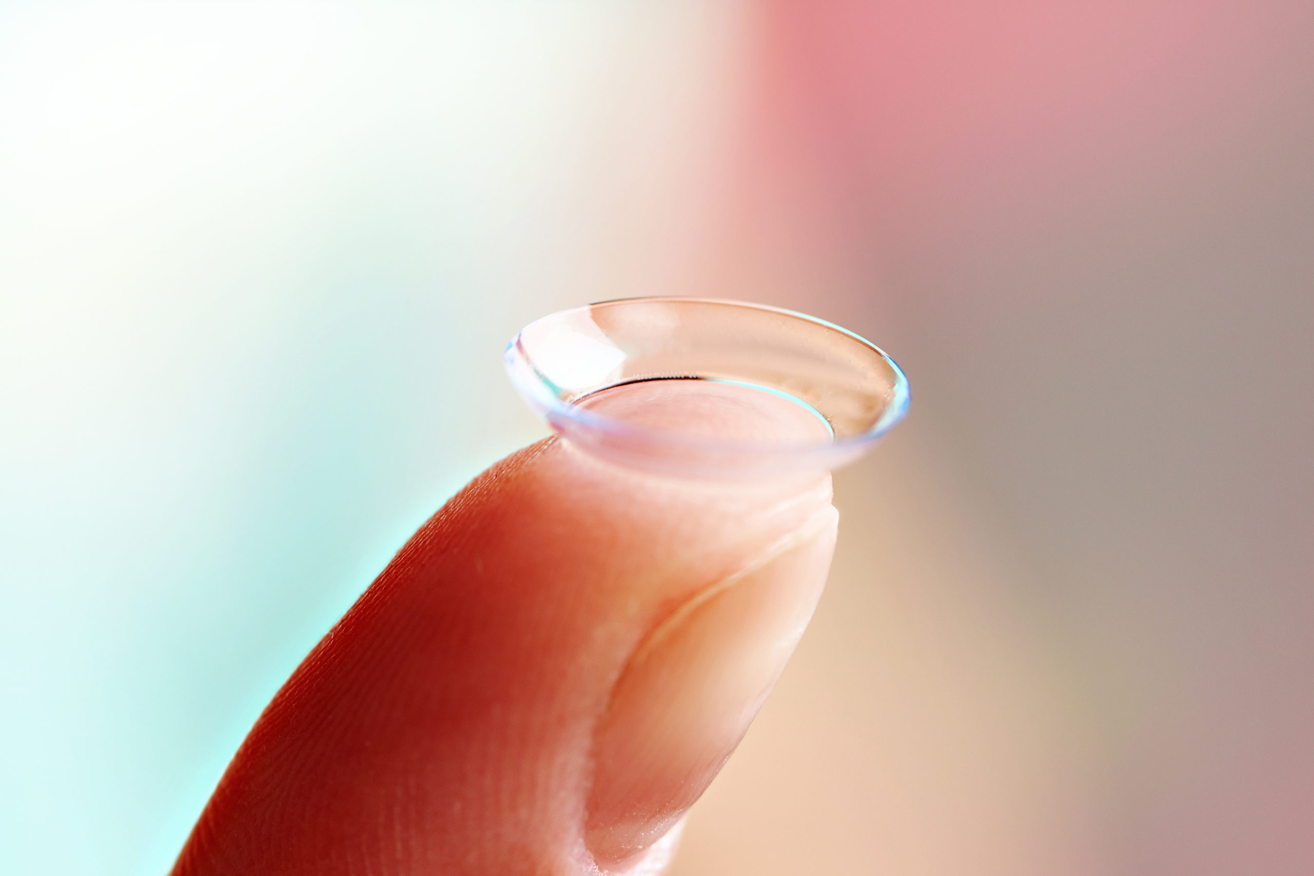 Womans finger with contact lens